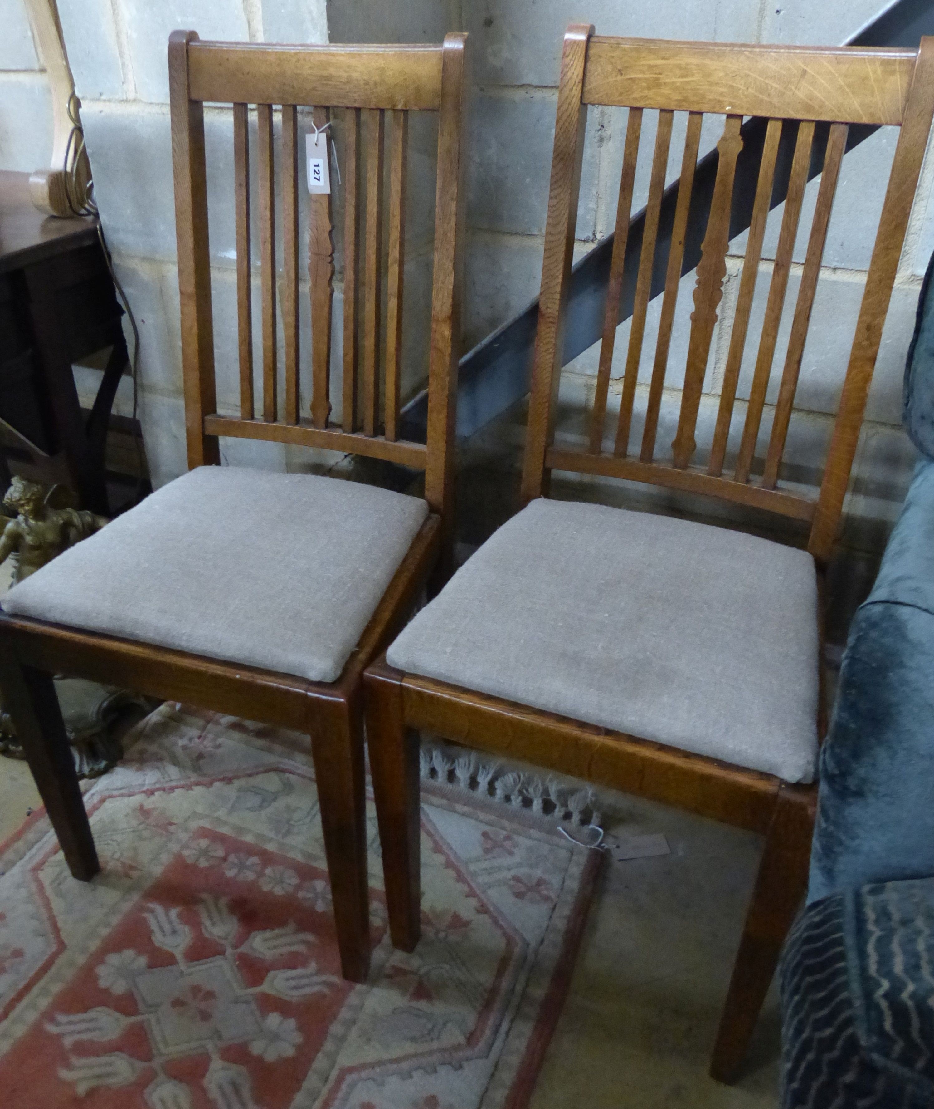 A set of four Edwardian oak dining chairs